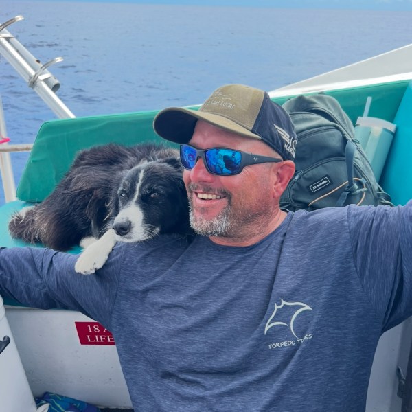 a man and a dog on a boat