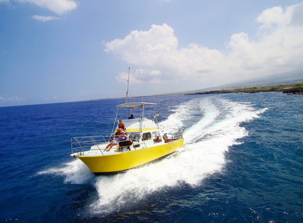 the torpedo tours boat cruising along the kona coast line